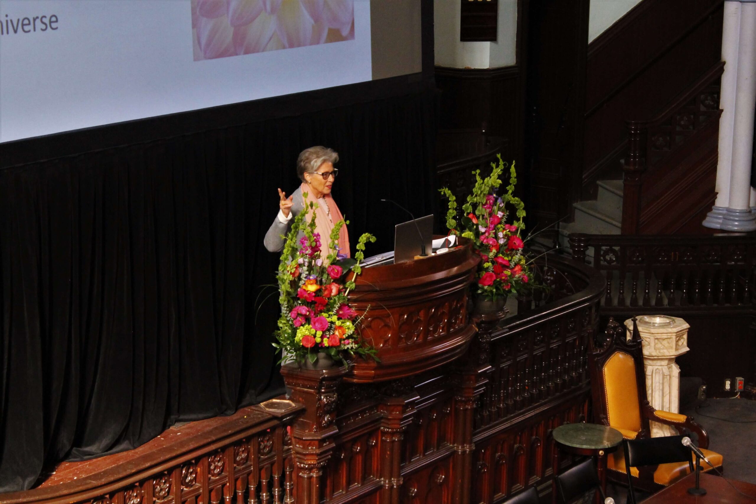 Madrinha Jessica Rochester speaking from a pulpit at a public gathering