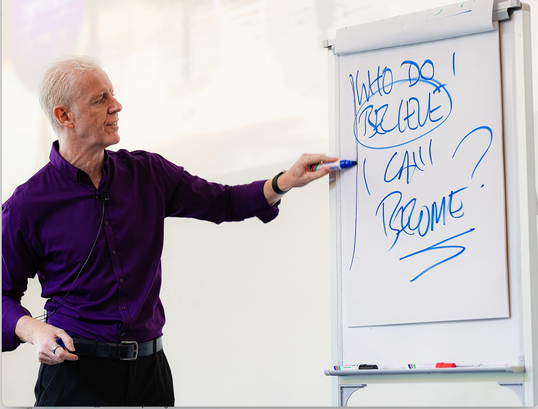 Marcus Marsden pointing to a flip chart that reads Who do I believe I can become