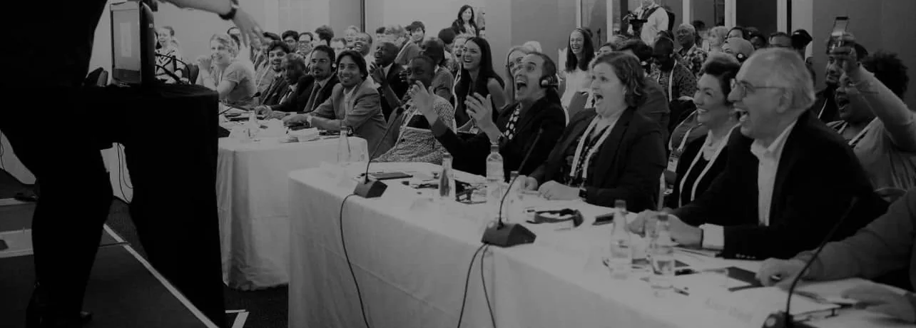 Conference audience laughing at a Sharon Miller keynote, in black and white